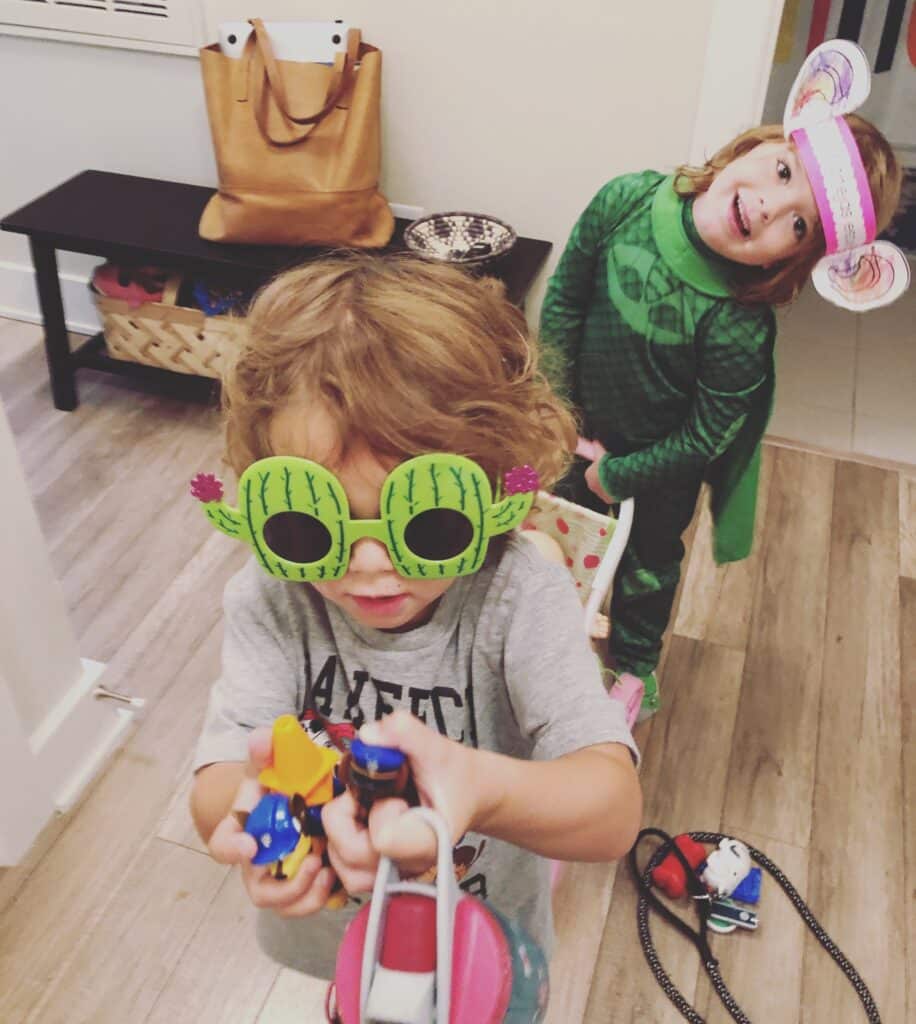 Fraternal twin girls that are dressed as in costumes to highlight their individuality