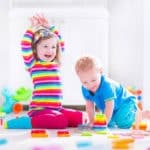 two kids playing on the floor creative play