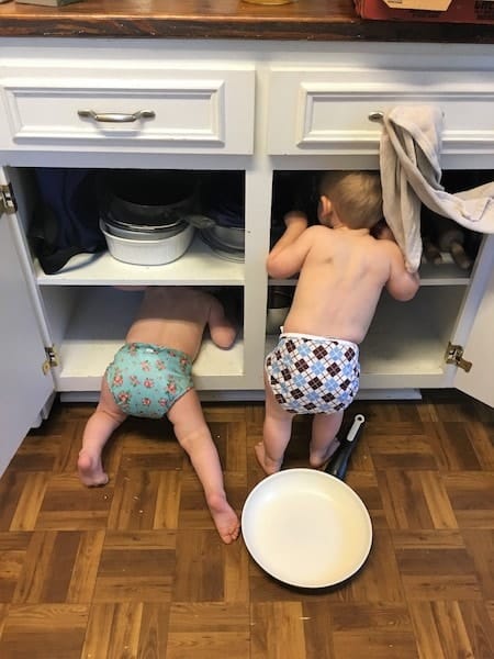 toddler twins looking through kitchen cabinets Keep Twins Busy