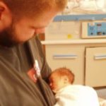 dad holding newborn baby