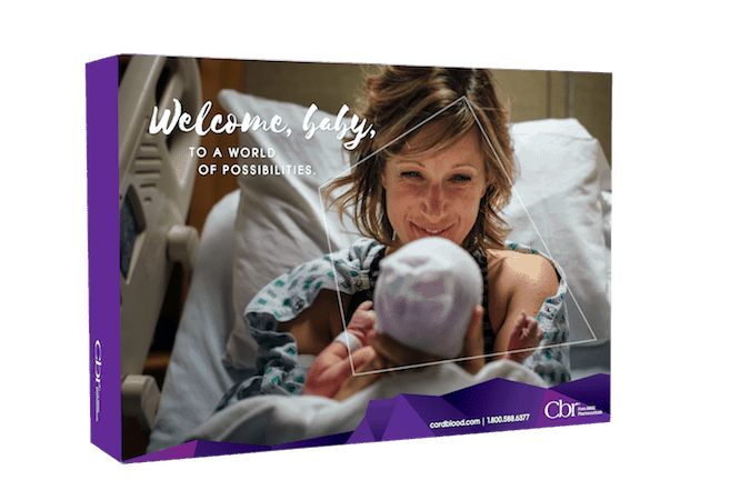 a woman holding a newborn with a hat on in a hospital bed shown on the cover of a CBR cord blood collection kit box.