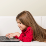free educational resources girl on couch with laptop